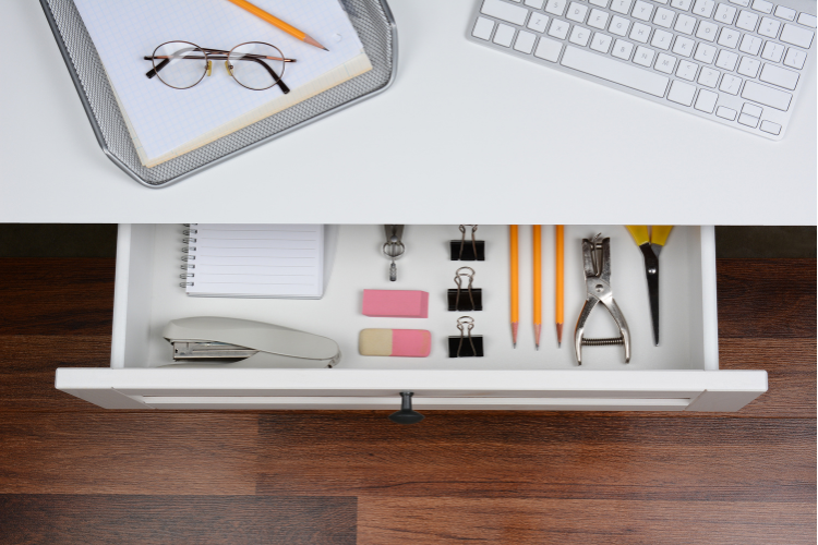 High angle shot of an open desk drawer